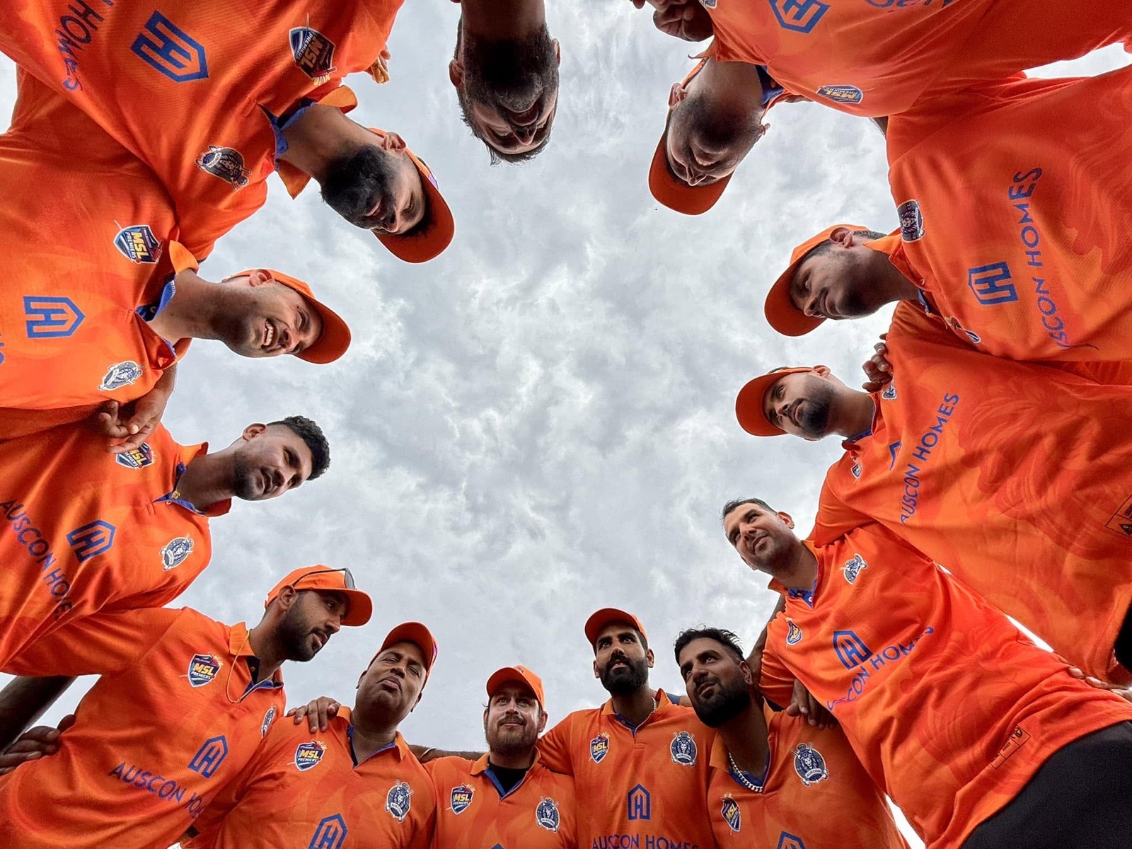 MSL Premiers players in a team huddle wearing Auscon Homes sponsored jerseys